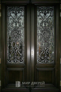 Кованая дверь со стеклом в дом №12 - фото №1